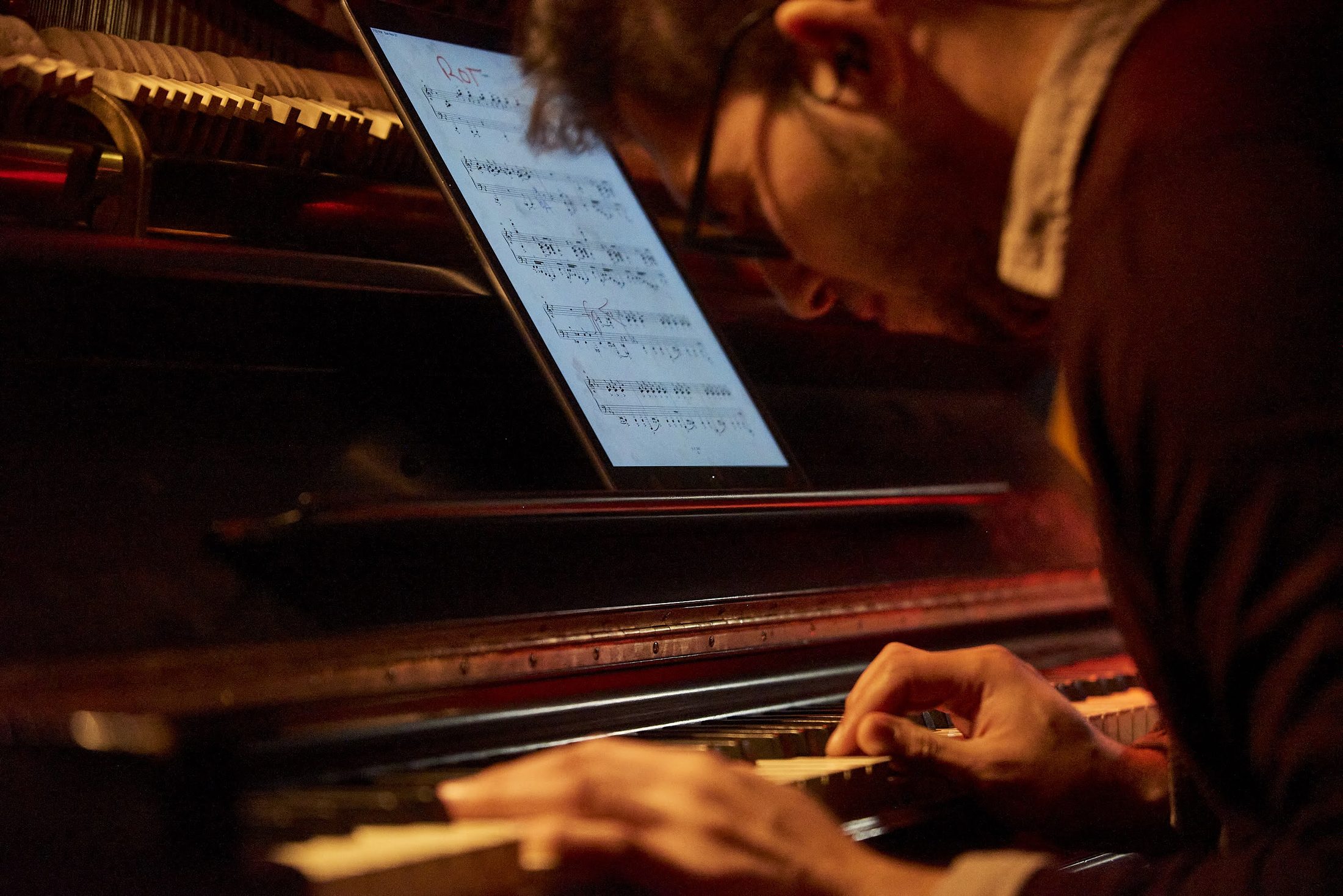 Luis Ramirez at the piano, working from a score